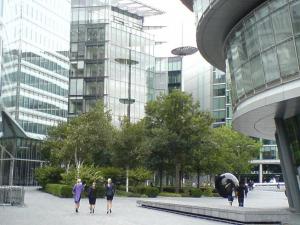 Office workers between glass and foliage on the south bank of the Thames, London Office workers between glass and foliage on the south bank of the Thames, London